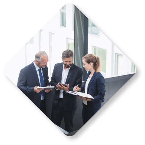 Three professionals reviewing business operations and outsourcing strategies on tablets.