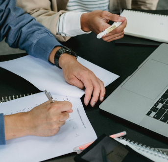 Team reviewing documents to identify hiring needs and define candidate personas.
