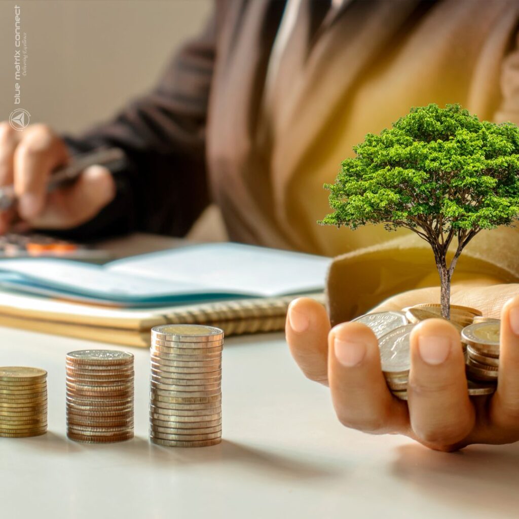 A businessperson working at a desk with a small plant growing from a stack of coins, representing sustainability, financial planning, and regulatory compliance.