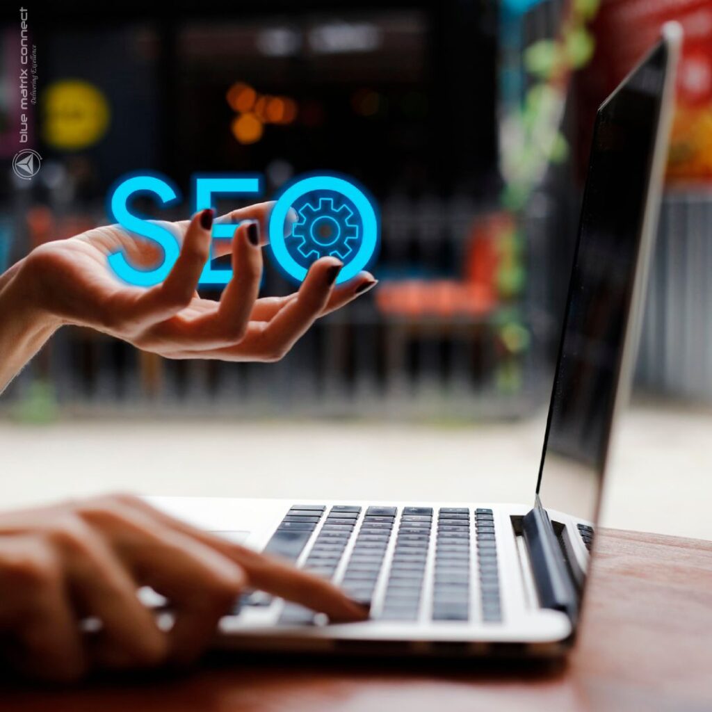 Person using laptop with an SEO icon hovering above their hand